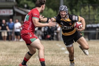 Community rugby players contest the ball during a club match in Wales
