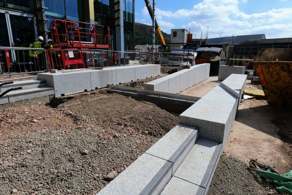 New granite steps and terraced seating blocks being laid outside Yr Aelwyd