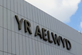 The Yr Aelwyd name in dark lettering on the grey cladding of Port Talbot's transformed theatre