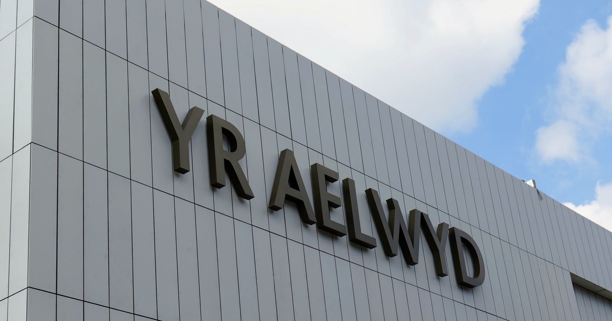 The Yr Aelwyd name in dark lettering on the grey cladding of Port Talbot's transformed theatre