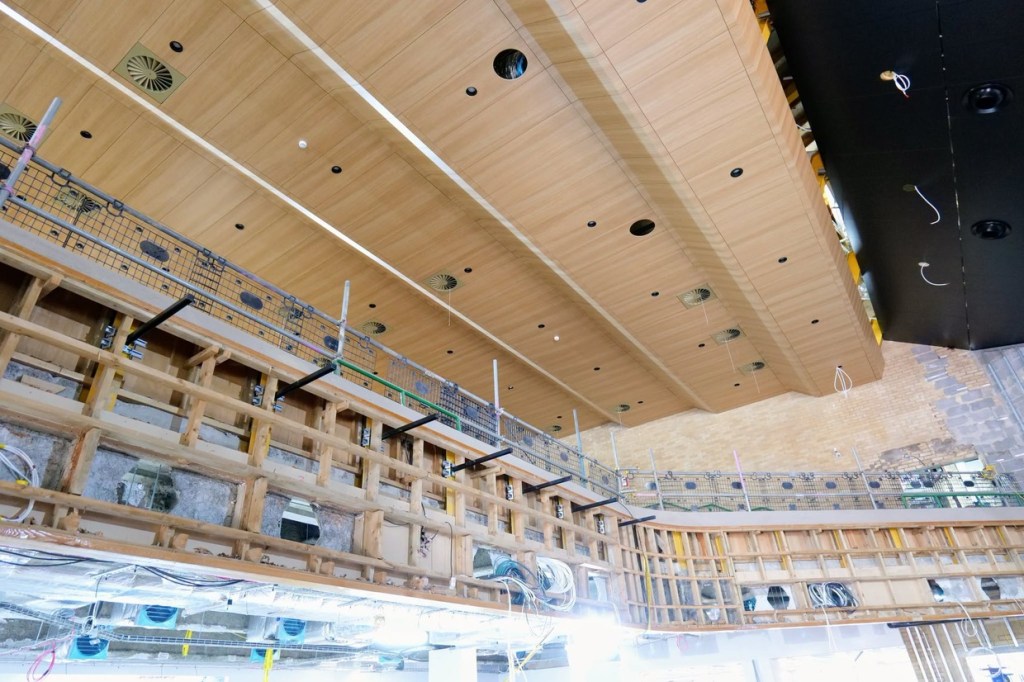 The balcony front stripped back to its original timber framework beneath the finished timber ceiling