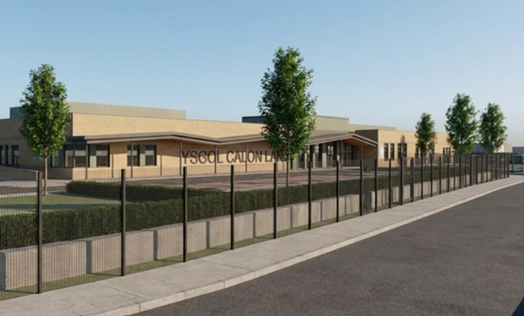 Architect's render of Ysgol Calon Lân seen from Mynydd Garnllwyd Road, a single-storey brick building with its name on the facade behind a fence, hedges and young trees
