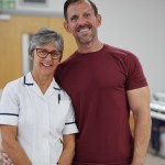 Andrew Jenkins and physiotherapist Clare Ford smiling together at Morriston Hospital.