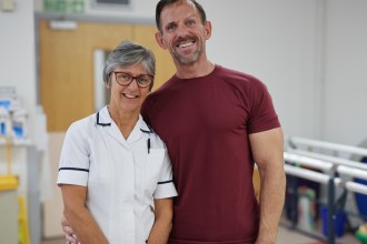 Andrew Jenkins and physiotherapist Clare Ford smiling together at Morriston Hospital.