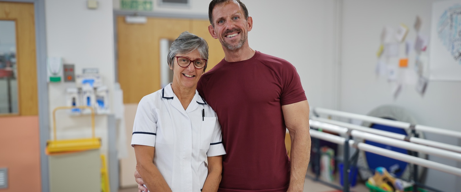 Andrew Jenkins and physiotherapist Clare Ford smiling together at Morriston Hospital.
