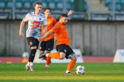 Pure Swansea striker Kyle Copp in the club's orange kit