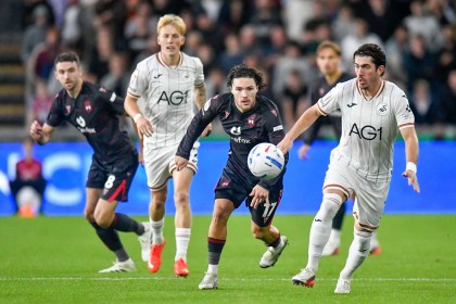 Swansea City's Josh Key under pressure from Wrexham's Callum O'Hare at the Swansea.com Stadium