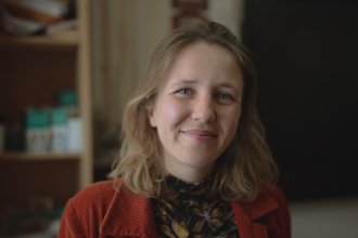 Jeanne Audren de Kerdrel, French and Spanish teacher at Ysgol Gymraeg Ystalyfera Bro Dur, smiling in a classroom in the S4C series Athrawon