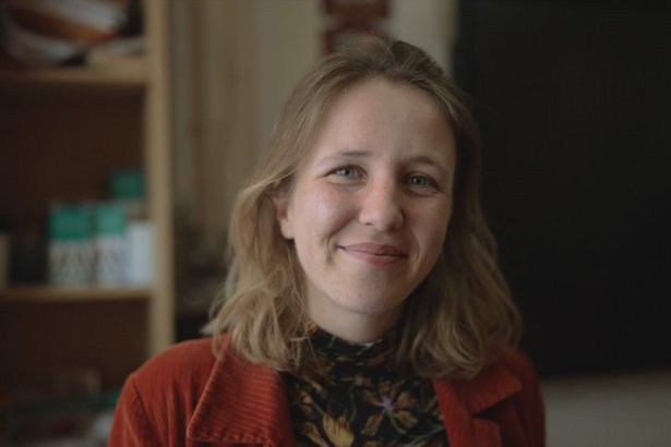 Jeanne Audren de Kerdrel, French and Spanish teacher at Ysgol Gymraeg Ystalyfera Bro Dur, smiling in a classroom in the S4C series Athrawon