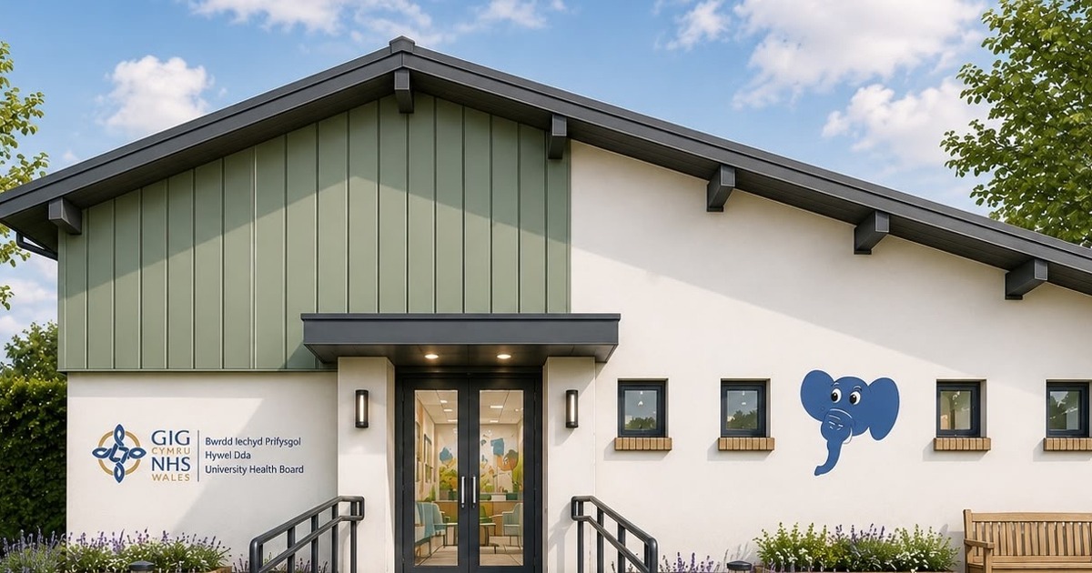Artist's impression of a single-storey children's centre with white and sage green walls, a blue elephant painted beside the windows and Hywel Dda NHS signage at the entrance