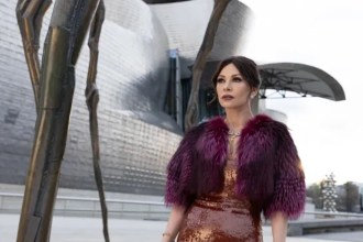 Catherine Zeta-Jones as Jackie Price in a sequinned dress and fur wrap outside the Guggenheim Bilbao in Kill Jackie