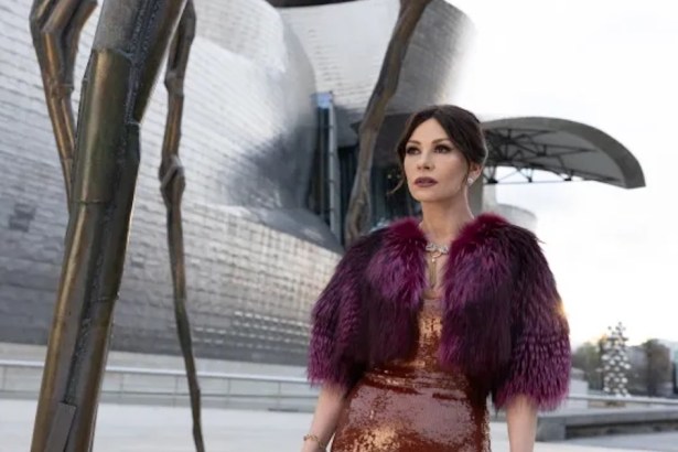 Catherine Zeta-Jones as Jackie Price in a sequinned dress and fur wrap outside the Guggenheim Bilbao in Kill Jackie
