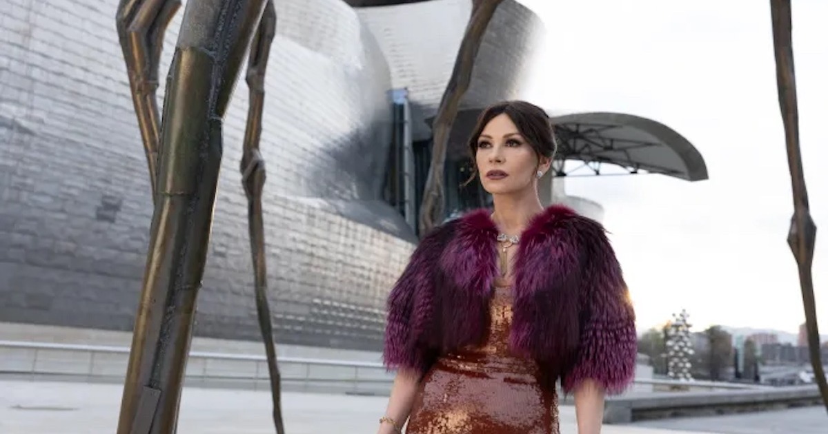 Catherine Zeta-Jones as Jackie Price in a sequinned dress and fur wrap outside the Guggenheim Bilbao in Kill Jackie