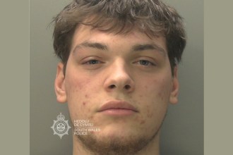 South Wales Police custody photograph of Daffydd Piper, a young man with short dark hair and light stubble