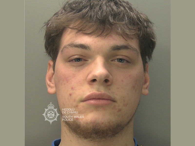 South Wales Police custody photograph of Daffydd Piper, a young man with short dark hair and light stubble