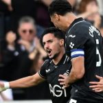 Swansea City's Stephen Eustáquio celebrates a goal with Ben Cabango