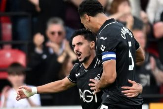 Swansea City's Stephen Eustáquio celebrates a goal with Ben Cabango