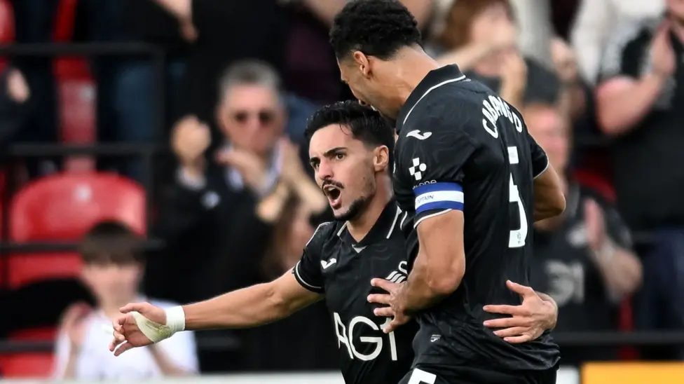 Swansea City's Stephen Eustáquio celebrates a goal with Ben Cabango
