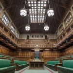 The empty green benches of the House of Commons chamber, looking towards the Speaker's chair