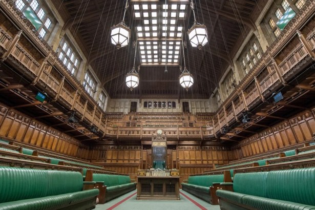 The empty green benches of the House of Commons chamber, looking towards the Speaker's chair