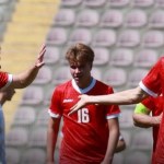 Wales regional side players celebrating a goal against Bitola, with Casey Coughlin on the right