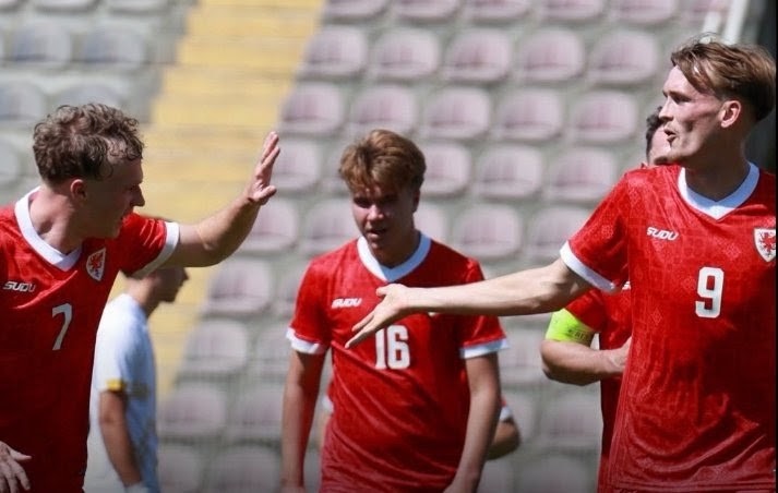 Wales regional side players celebrating a goal against Bitola, with Casey Coughlin on the right