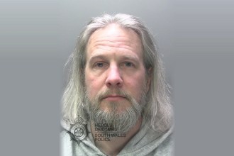 South Wales Police custody photograph of James Miller, a man with long grey hair and a grey beard