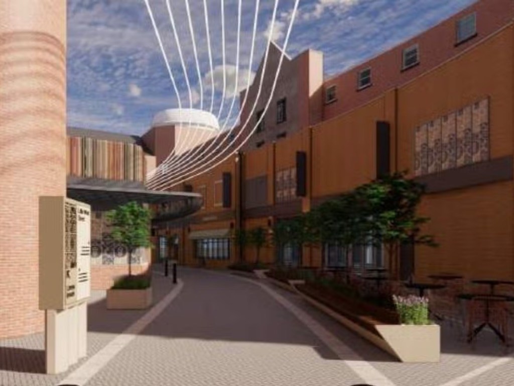 Architect's render looking along Little Wind Street with curved strings of light overhead, brick facades, planters with small trees and outdoor tables