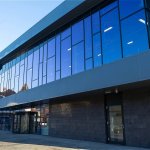 The new leisure centre in Neath town centre, with dark curved cladding wrapping a fully glazed upper storey