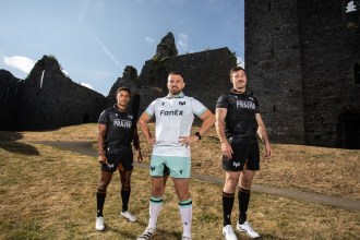 Three Ospreys players in the new 2026/27 kits, two in the black home shirt and one in the white and teal away shirt, at a ruined castle