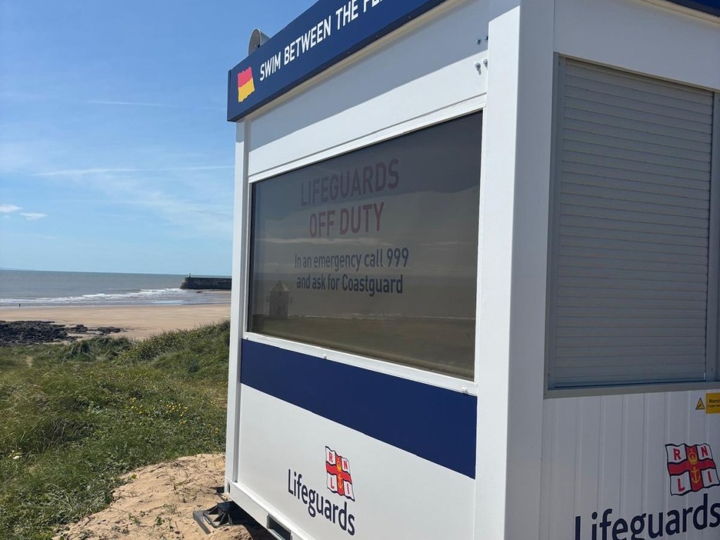 Side of a new RNLI lifeguard unit with a tinted front window and loudspeakers on the roof