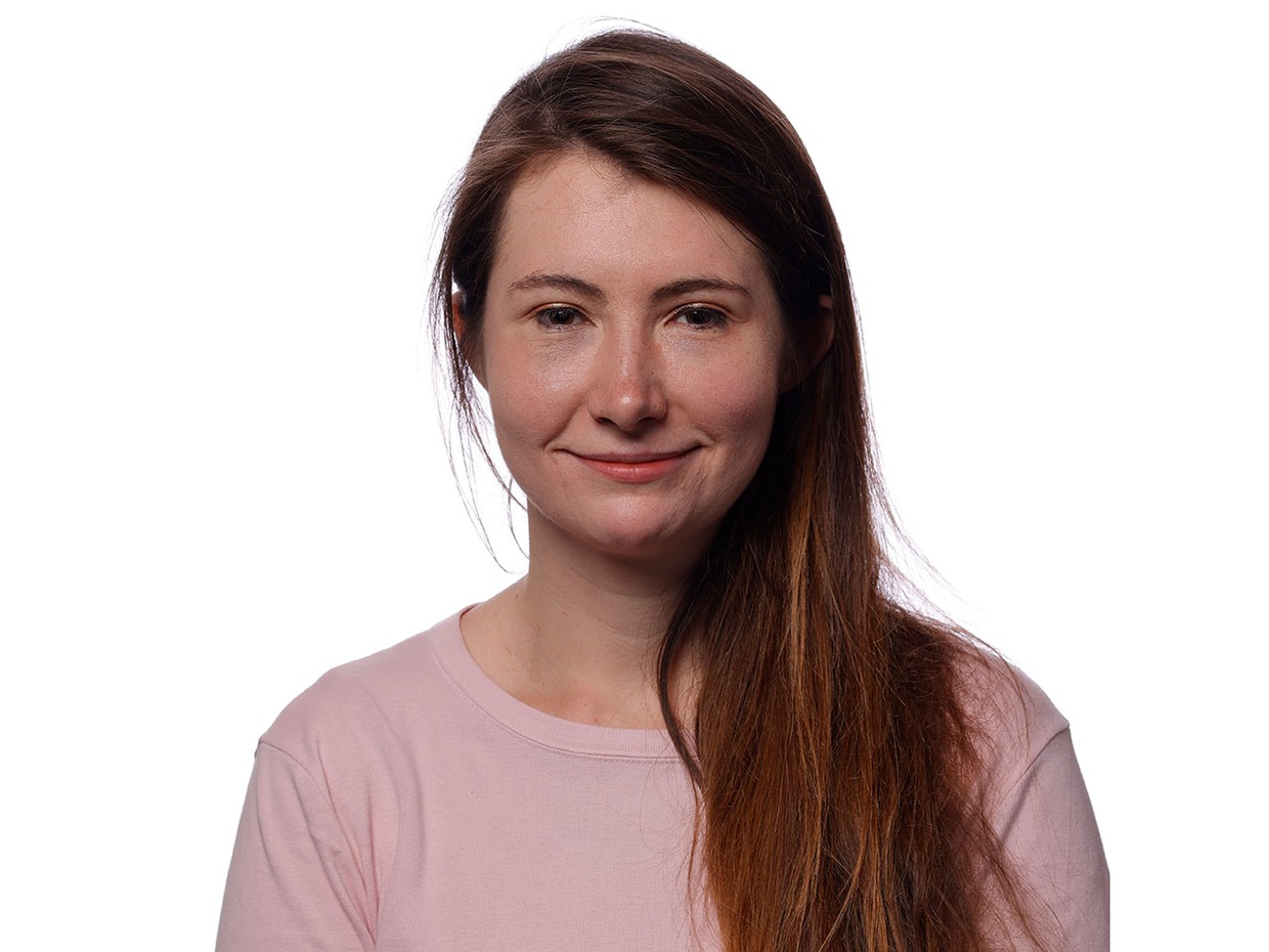 Official Senedd portrait of Sarah Cooper-Lesadd MS, smiling, with long auburn hair, in a pale pink top against a white background