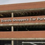 Close-up of the white St David's Shoppers Car Park lettering and bishop emblem on the red-brick multi-storey