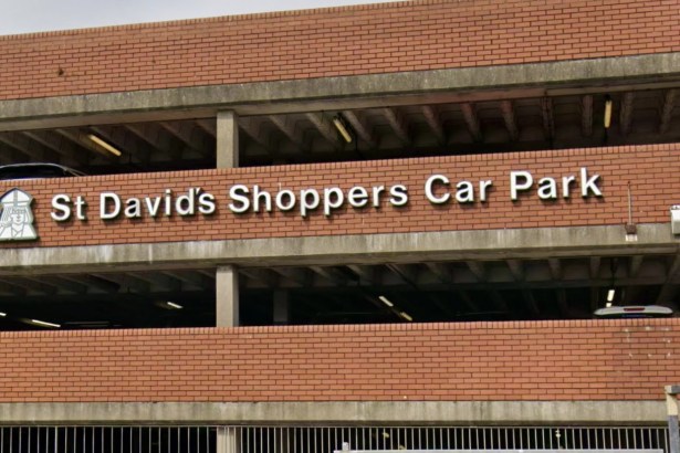 Close-up of the white St David's Shoppers Car Park lettering and bishop emblem on the red-brick multi-storey