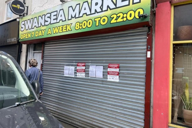The shuttered Swansea Market shop on St Helens Road with court closure notices taped to the shutter