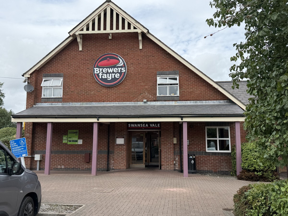 The Swansea Vale Brewers Fayre in Llansamlet with its entrance doors open beneath the Brewers Fayre sign on the brand's final day of trading