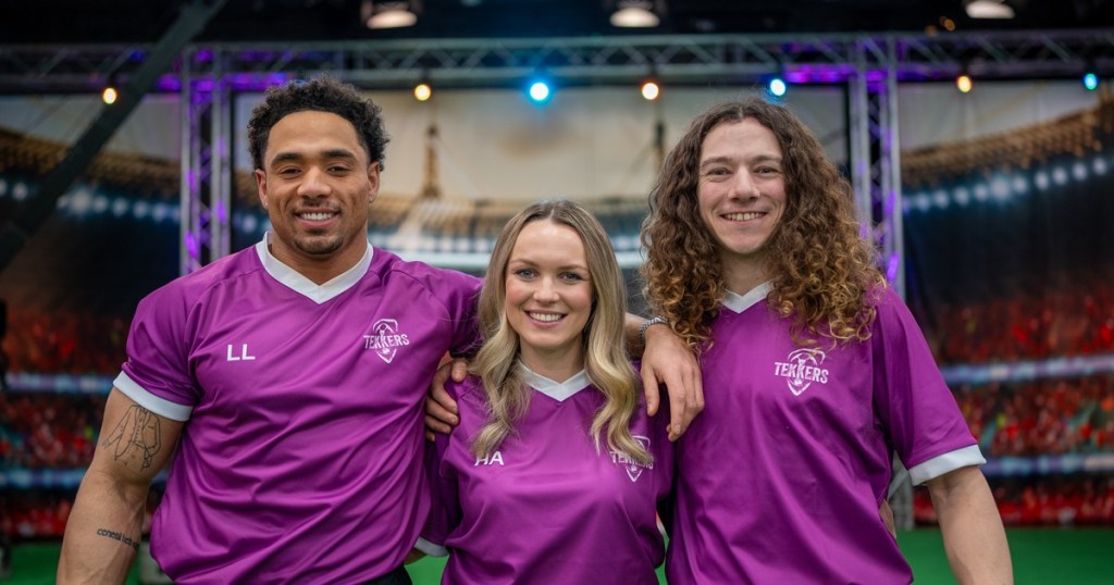 Three Tekkers presenters in purple football shirts standing in the show's studio stadium set