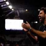 Swansea City head coach Vitor Matos applauding and laughing under the floodlights at the Swansea.com Stadium