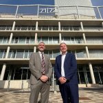 IWG's Mark Potton and council leader Rob Stewart in suits outside the glass and concrete 71/72 Kingsway office building, with the 71/72 sign on its roof