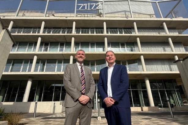 IWG's Mark Potton and council leader Rob Stewart in suits outside the glass and concrete 71/72 Kingsway office building, with the 71/72 sign on its roof