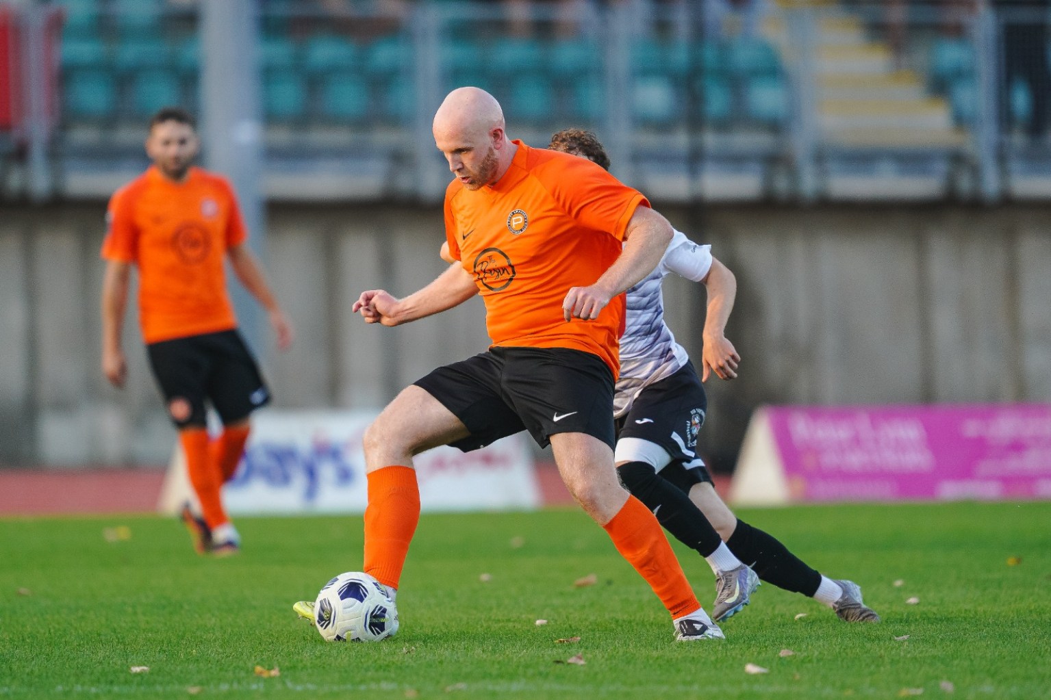 Pure Swansea centre-half Ollie Roberts in the club's orange kit