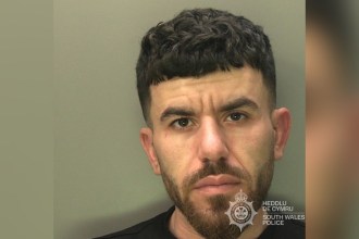 South Wales Police custody photograph of Abdullah Saed, a man with short dark curly hair and a beard