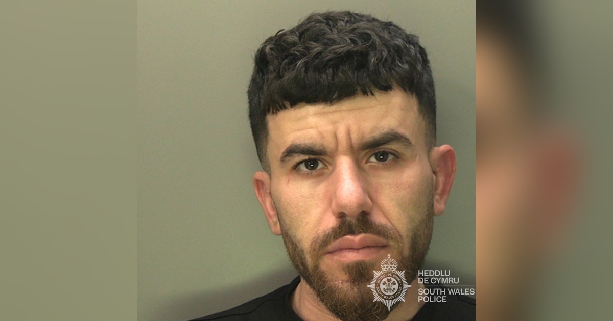 South Wales Police custody photograph of Abdullah Saed, a man with short dark curly hair and a beard