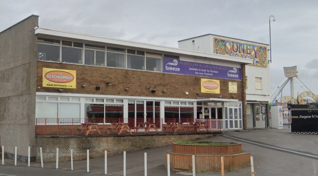 The Beachcomber in Porthcawl, a two-storey brick venue with yellow Beachcomber signs and a purple Breeze nightclub banner, beside the Coney Beach funfair