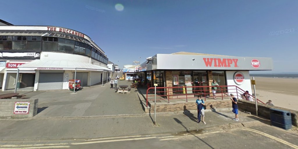 The Buccaneer bar and the Wimpy restaurant side by side on Porthcawl seafront, with the beach to the right