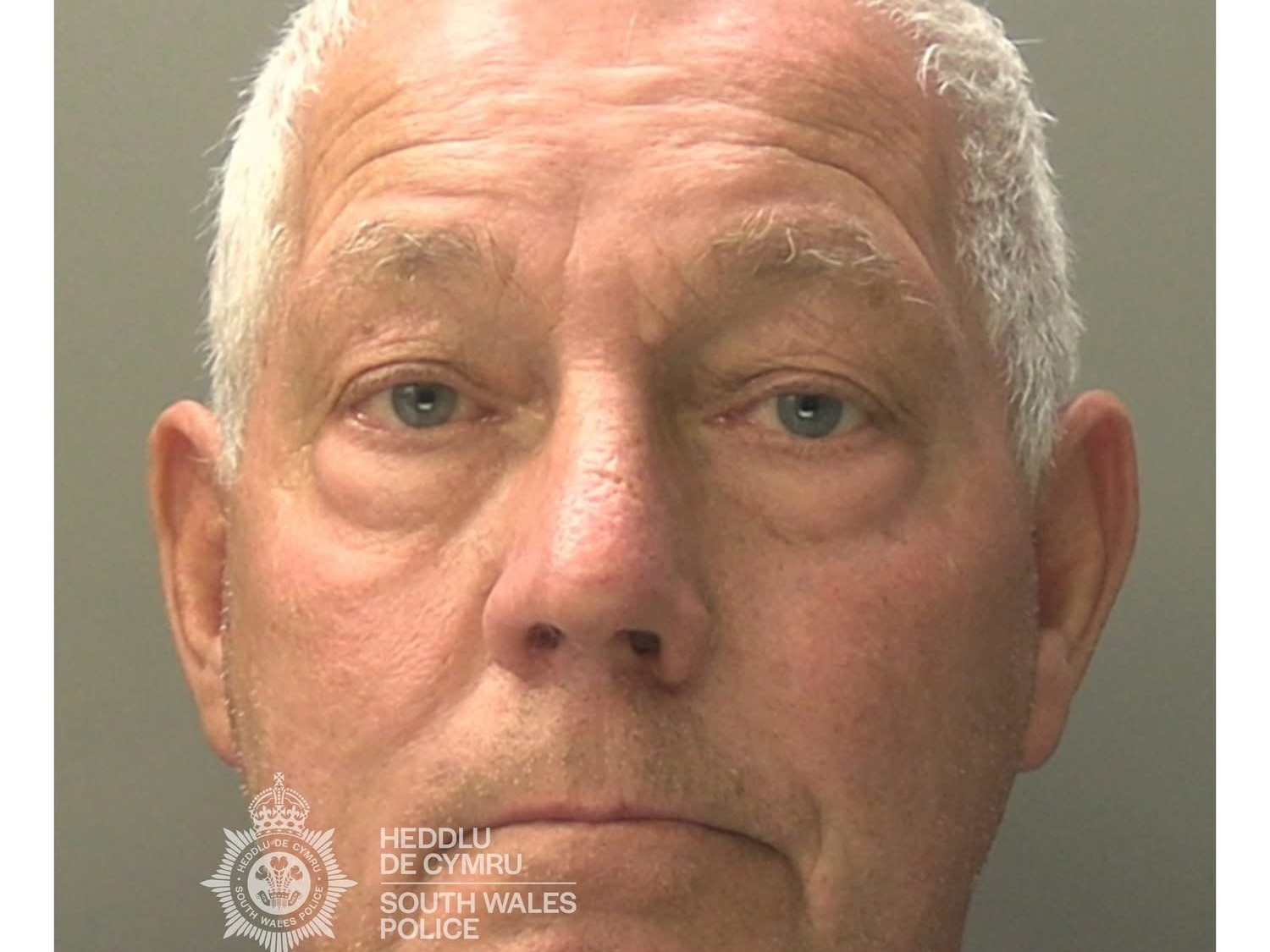 Custody photograph of Christopher Williams, a grey-haired man in his seventies, issued by South Wales Police