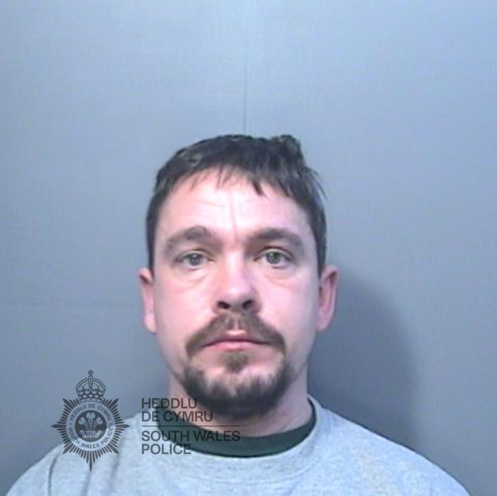 Police custody photograph of Damien Samuel, a man with short dark hair and a goatee beard in a grey top