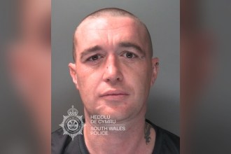South Wales Police custody photograph of Daniel Green, a man with a shaved head and a neck tattoo