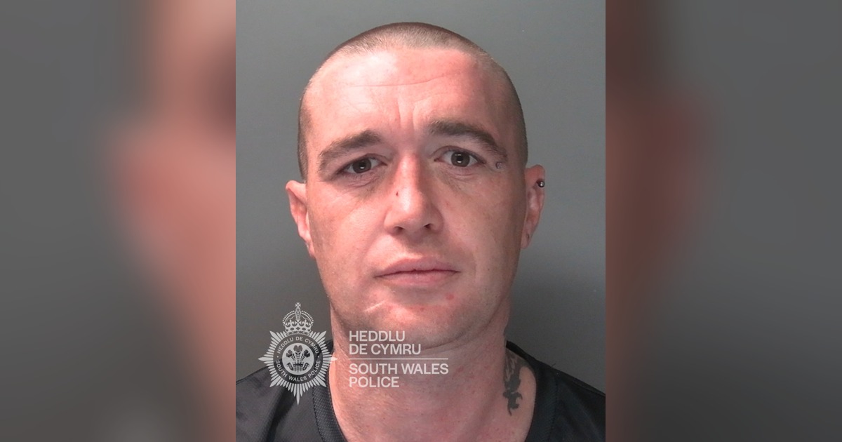 South Wales Police custody photograph of Daniel Green, a man with a shaved head and a neck tattoo