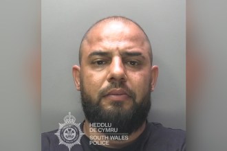 South Wales Police custody photograph of David Novac, a man with a shaved head and a dark beard